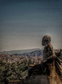 Statue of cityscape against sky