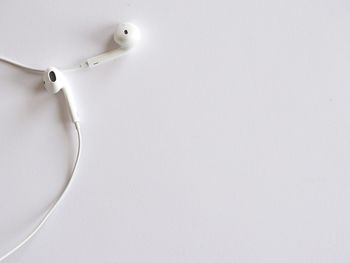 High angle view of white earphones 