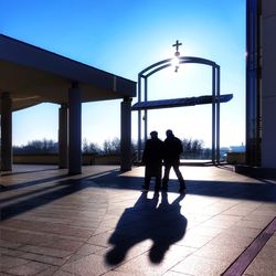 Silhouette men on sunny day