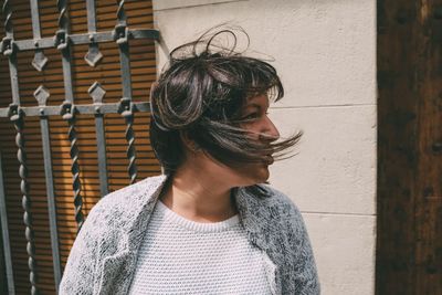 Close-up of woman standing against wall