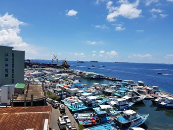 High angle view of harbor by sea against sky