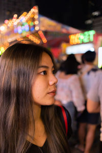 Close-up of young woman looking away outdoors