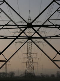 Low angle view of electricity pylon against sky