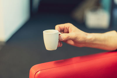 Cropped hand holding coffee