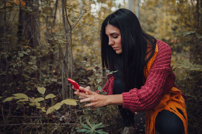 Young woman looking at camera in forest