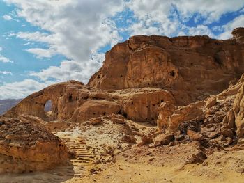 View of rock formations against cloudy sky