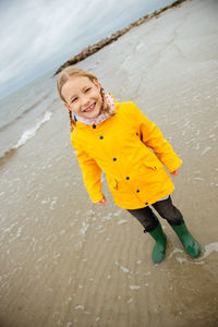 Full length portrait of girl standing at beach