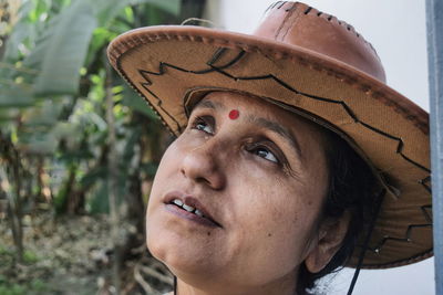 Close-up of thoughtful woman wearing hat