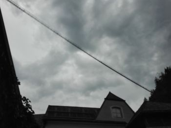 Low angle view of building against cloudy sky