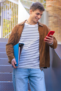 Portrait of young man standing in city