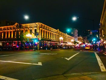 Illuminated city street at night