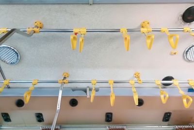 Close-up of clothes hanging on railing against wall