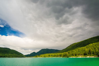 Scenic view of lake and mountains against sky