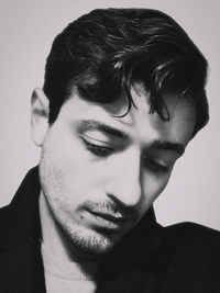 Close-up portrait of young man against white background