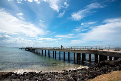 Pier over sea against sky