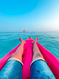 Low section of man relaxing in swimming pool