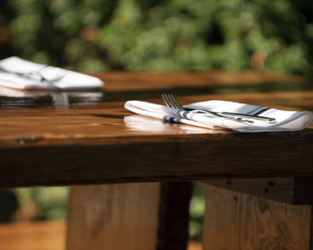 Close-up of fork and napkin on dining table