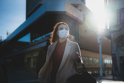 Midsection of woman standing in city