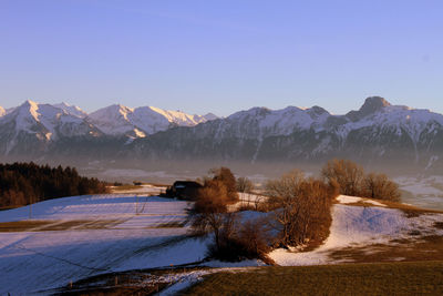 Scenic view of snowcapped mountains against clear sky