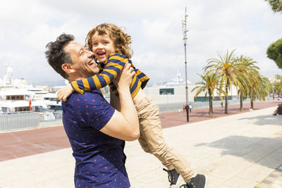 Spain, barcelona, father and son playing together and having fun