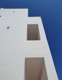 Low angle view of white  house against blue sky