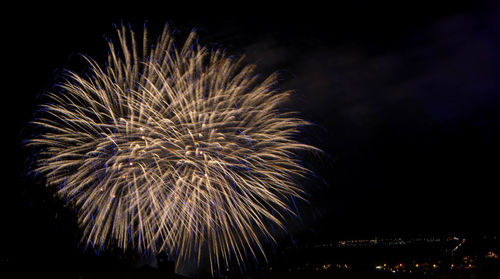 Low angle view of firework display at night