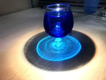 High angle view of blue glass on table