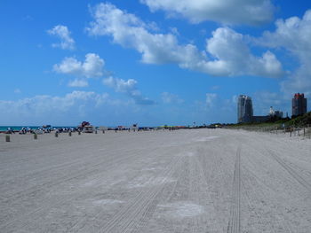 Group of people on road against sky