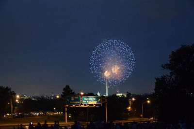 Low angle view of illuminated fireworks against sky at night