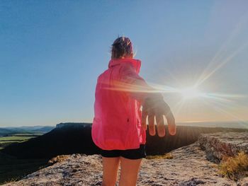 Rear view of woman looking at mountain against sky