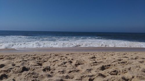 Scenic view of beach against clear sky