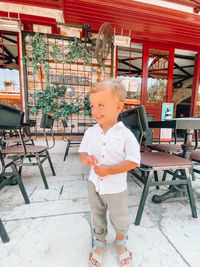 Full length of cute boy standing on table