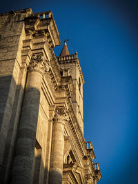 Low angle view of historical building against blue sky