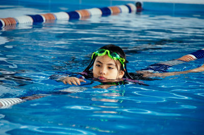 Portrait of boy swimming in pool