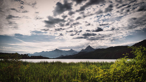 Scenic view of lake and mountains against sky