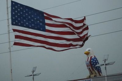 Low angle view of flags against clear sky