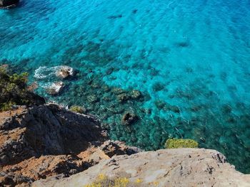 High angle view of rocks by sea