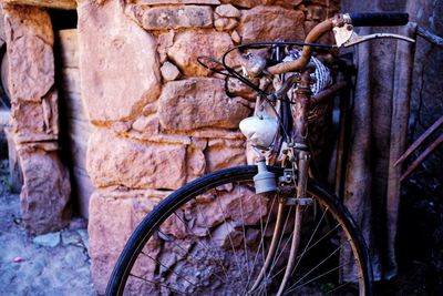 Close-up of bicycle wheel against wall