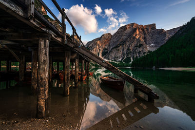 Wooden structure in lake against sky