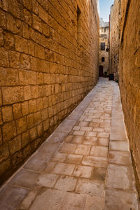 View of alley amidst buildings