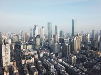 Aerial view of modern buildings in city against sky