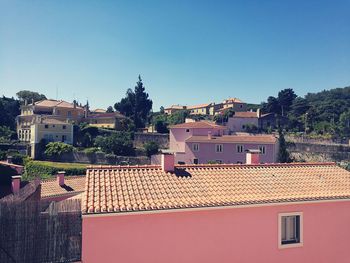 Houses in town against clear sky