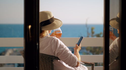 Rear view of woman using mobile phone