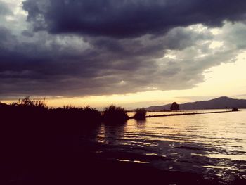 Scenic view of lake against sky during sunset