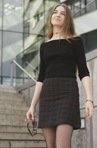 Full length of young woman standing outdoors
