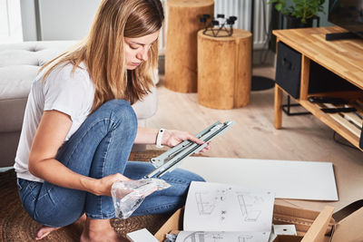 Woman working on table at home