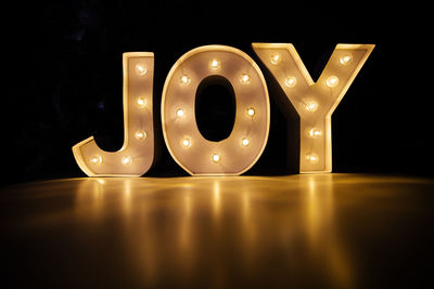 Close-up of illuminated text on table