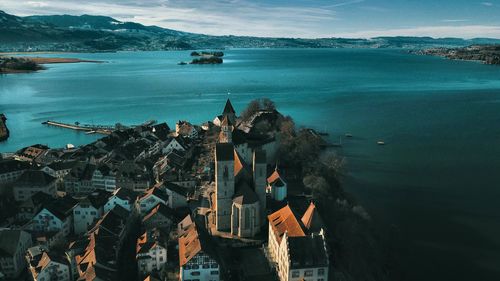 High angle view of buildings by sea