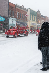 Rear view of people in snow