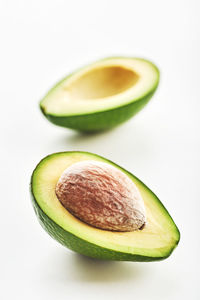 Avocado cut in half isolated on a white background